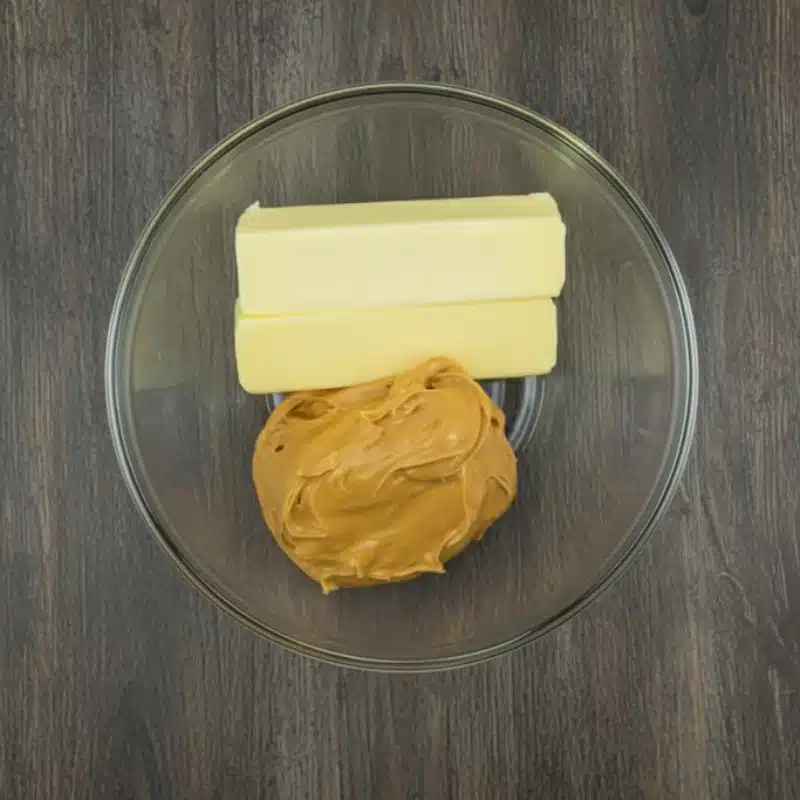 Unsalted butter and creamy peanut butter in a glass bowl before being melted to make 3 ingredient fudge.